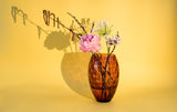 Violet Kugel Vase Tall with pale pink flowers and a light yellow background